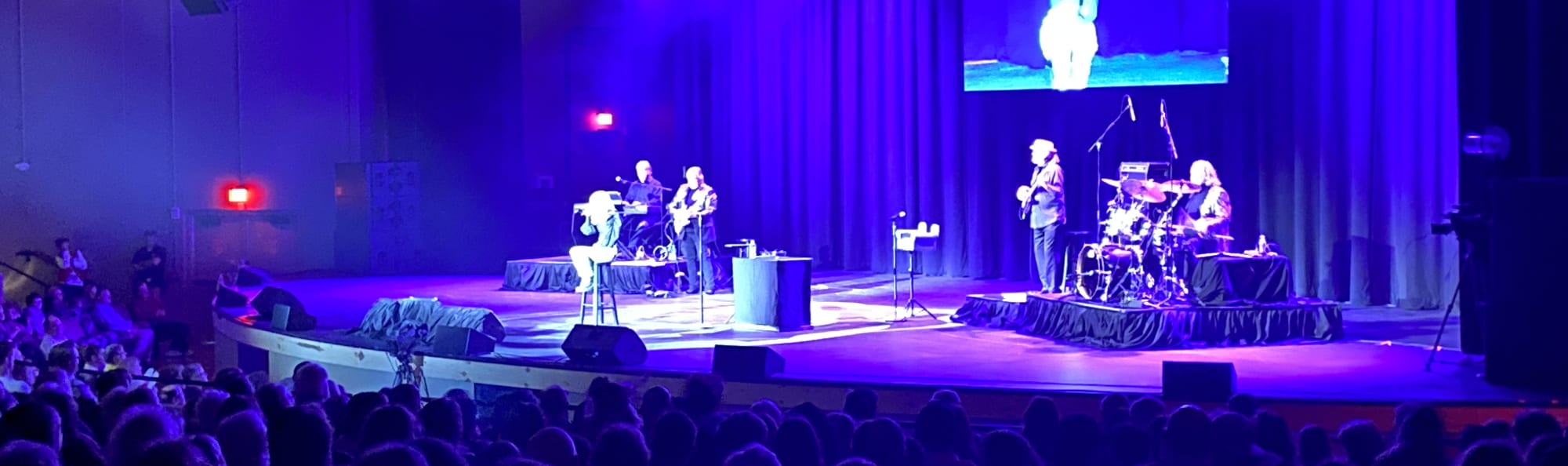 signer on stage in chair washed out by the lights McAllen